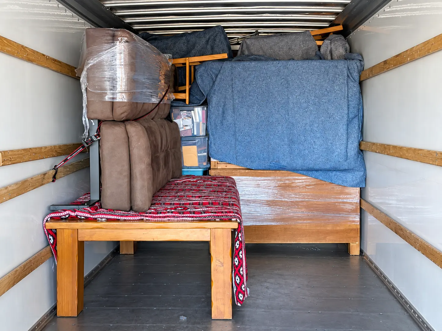 Furniture padded, wrapped, and secured inside a moving truck during an Easy Eight local move.